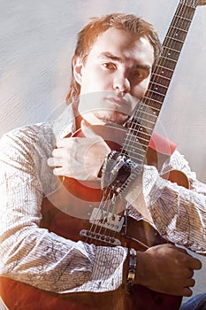 Music Concepts. Portrait of Young Male Guitar Player Posing with