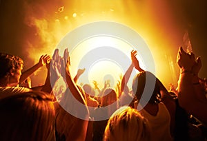 Music, concert and crowd with light, clapping for live performance, rock event and band on stage at night. People
