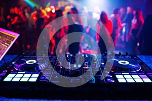 music controller DJ mixer in a nightclub at a party photo