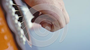 Music, creativity, concert, self-isolation concept. Close-up hands of young man playing an acoustic guitar dreadnought