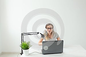 Music, dj, blogging and broadcasting concept - Female radio host with a funny expression