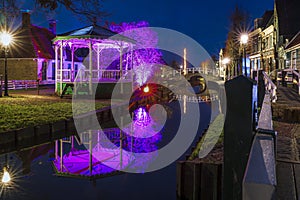 Music dome in a characteristic village center with colorful lighting at night