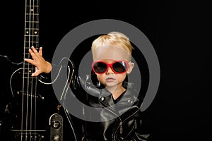 Music for everyone. Adorable small music fan. Small musician. Little rock star. Child boy with guitar. Little guitarist