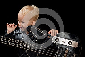 Music festival. Rock style child. Little rock star. Child boy with guitar. Little guitarist in rocker jacket. Rock and