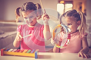 Music is good for all . Little girls at music class.