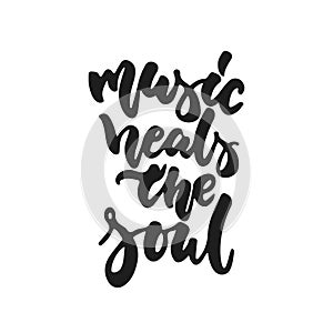 Music heals the soul - hand drawn lettering quote isolated on the white background. Fun brush ink vector illustration