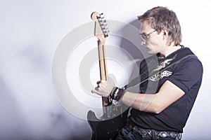 Music Ideas and Concepts. Male Guitar Player Posing With Guitar