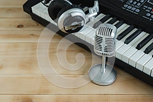 Music instrument tools concept background. Close up group of musical tools the silver michophone, headphone,electronic keyboard on