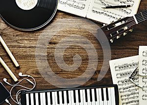 Music instruments and earphones on wooden table