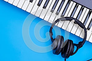 Music keyboard and Music headphone on blue