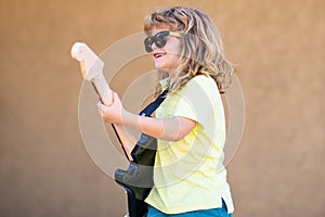 Music kids. Boy guitarist. Portrait of 6 years old boy.