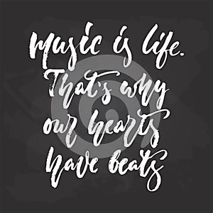 Music is life. That`s why our hearts have beats - hand drawn Musical lettering phrase isolated on the black chalkboard