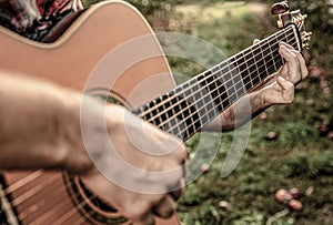 Music lifestyle man playing guitar nature concept. Hands of man musician playing guitar. Music concept. Man& x27;s hands