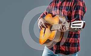 Music lifestyle man playing guitar. Playing an acoustic guitar. Guitarist hands and guitar. Mans hands playing