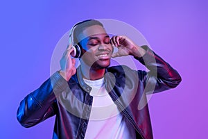 Music Lover. Handsome Black Guy In Wireless Headphones Listening His Favorite Songs