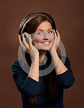 Music lover. Smiling woman in headphones