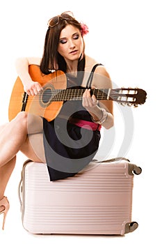 Music lover, summer girl with guitar and suitcase