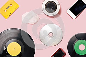 Music mediums over time concept. EP and LP vinyl, cassette tape, CD, mp3 player, cell phone, portable speaker cotton cloud shaped