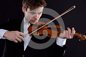 Music, misery, the concept of bad luck. The young violinist is elegantly dressed, shaken, and has a broken bow.