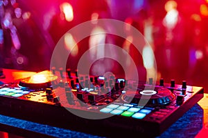 Music mixer DJ controller in booth at nightclub