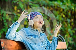 Music is so much fun. modern technology instead of reading. relax in park. hipster girl with mp3 player. listening music