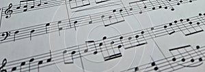 Music notes background. Musical concept macro view of white score sheet music