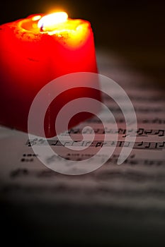Music Notes Sheet in a Red Candle Light