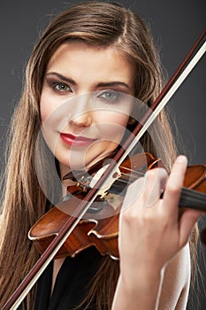 Music portrait of young woman. Violin play.