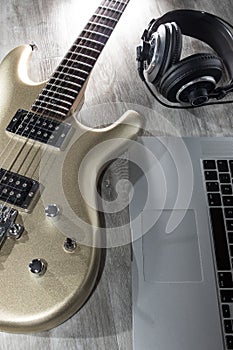 Music production. Recording music with an electric guitar, laptop computer and headphones