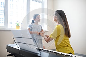 Girl and her teacher communicating at the lesson photo