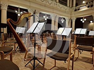 Music score with notes in hall of the conservatory at classical music concert