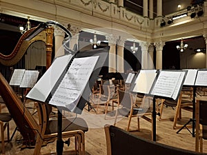 Music score with notes in hall of the conservatory at classical music concert