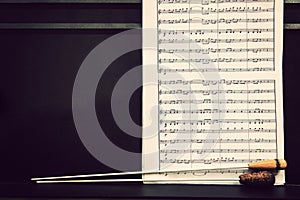 Music sheets and conductor`s batons