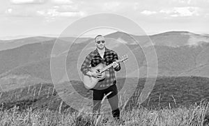Music for soul. Playing music. Sound of freedom. In unison with nature. Acoustic music. Musician hiker find inspiration