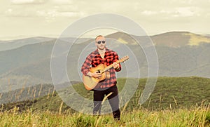 Music for soul. Playing music. Sound of freedom. In unison with nature. Acoustic music. Musician hiker find inspiration