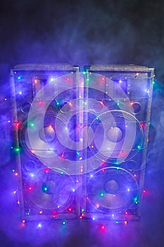 Music speakers with festive Christmas lights and smoke