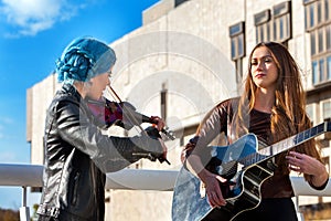 Music street performers with girl violinist. Autumn mood.