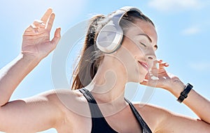Music, summer and dance with a woman outdoor in nature against a blue sky for dancing or freedom. Radio, relax and