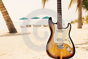Music summer holiday composition with close up electronic guitar on blurred sand beach landscape background