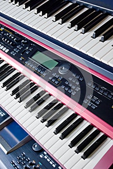 music synthesizer keyboards on rack