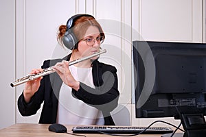 A music teacher conducts a lesson on playing a musical instrument over the Internet. Flute lessons online and online music