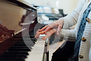 Music teacher helps student to play correctly