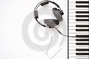 Music template with keyboard synthesizer with headphone on white background