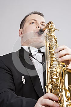 Music Themes and Ideas. One Caucasian Male Saxophonist Playing Saxophone