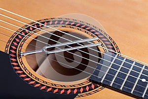 Music tuning fork on acoustic guitar strings
