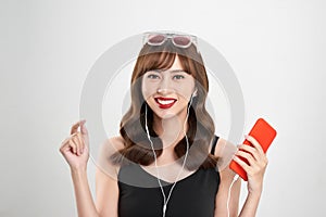 Music. Woman dancing with earbuds / headphones listening to music on mp3 player