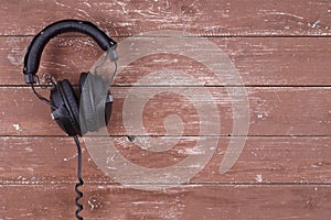 Musical equipment - Black headphone wooden background