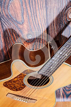 Close up of acoustic guitar. Acoustic guitar against an old wooden background