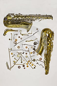 Disassembled saxophone with details and pads.