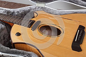 Musical instrument - Closeup fragment Broken acoustic guitar in case